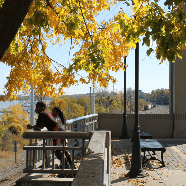 Two people leaning against the railing at Rotary Centennial Park