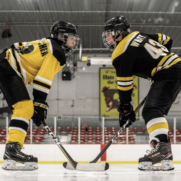 Two hockey players facing off at Washington Park Ice Arena